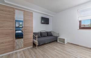 a bedroom with a couch and a tv in a room at Apartment Maria in Vodnjan