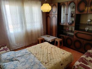 a bedroom with two beds and two stools in it at Villa Shine Apartment 1 in Struga