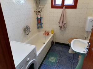 a bathroom with a tub and a sink and a washing machine at Villa Shine Apartment 1 in Struga +12 photos