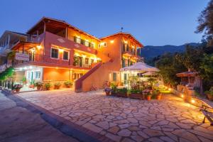 a large building with a patio in front of it at Cleopatra rooms in Nikiana
