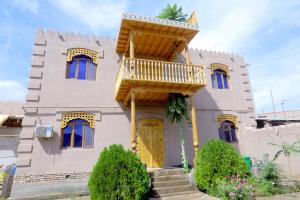 una casa con balcón en la parte delantera en Shahriston - Hotel Khiva, en Khiva 21 fotos más