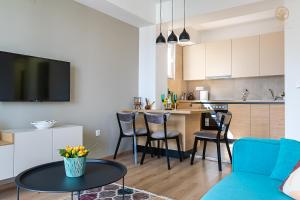 a living room and kitchen with a table and chairs at La Vita Apartment 2 in Ohrid