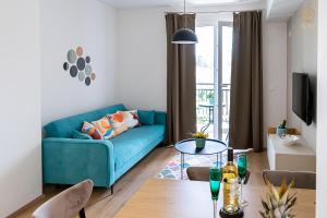 a living room with a blue couch and a table at La Vita Apartment 2 in Ohrid