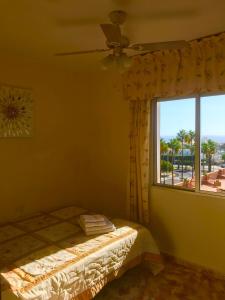 a bedroom with a bed and a window with a view at SEA-VIEW APARTMENT WITH a TENNIS COURT in Adeje