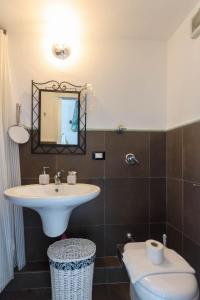 a bathroom with a sink and a toilet at Le Casuzze di Trapani Vista Mare in Trapani