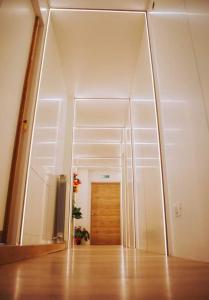 a hallway with a mirror and a wooden door at Avezzano 3e60 in Avezzano