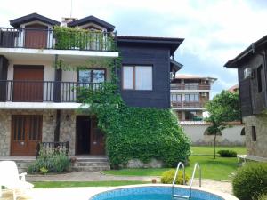 a house with a swimming pool in front of it at Paradise Bay Villas in Sozopol
