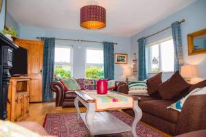 a living room with a couch and a table at Teac Treasa in Gweedore