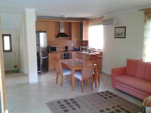 a kitchen and living room with a table and a couch at Paradise Bay Villas in Sozopol