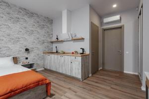 a bedroom with a bed and a kitchen in it at Fishel in Odesa