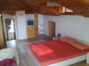 a bedroom with a large red bed in a room at Paradise Bay Villas in Sozopol +39 photos