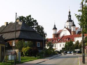 an old building with two towers on a street at Apartament Leśny in Supraśl