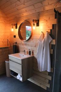 a bathroom with a sink and a mirror at Hiška-Glamping in Ajdovščina