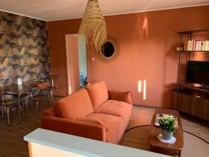 a living room with a couch and a table at LE FIFTIES in Verdun