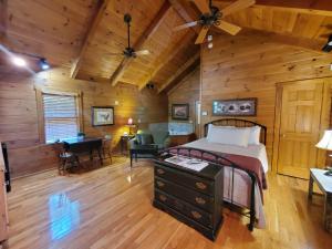 a bedroom with a bed and a desk in a room at New River Trail Cabins in Galax