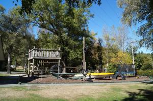 a park with a playground with a surfboard and a boat at Alpine Adventure Holiday Park in Hanmer Springs