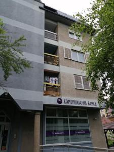 a building with a sign on the side of it at Apartman Bogdanović Sokobanja in Soko Banja