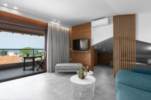 a living room with a couch and a table at Pola's loft in Ierissos