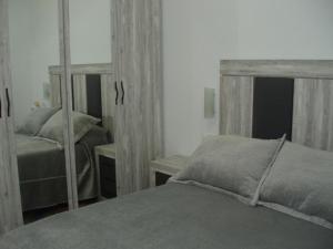 a bedroom with a bed and a mirror at Cordoba Tourist Apartments in Córdoba