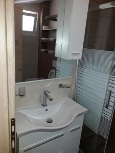 a bathroom with a sink and a mirror at Adriatic Sunset House in Petrovac na Moru +9 photos