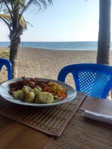 a plate of food on a table at the beach at Dulce y Salado in La Curbina