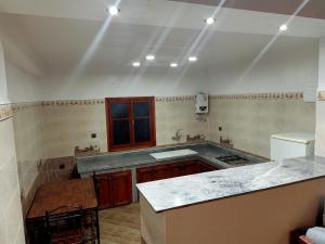 an empty kitchen with a counter and a sink at Jardin de rayane in Essaouira