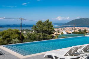 a villa with a swimming pool and a view at Voula Villa Luxury in Lefkada Town