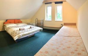 a bedroom with a bed and a window at Domček Ami in Stará Lesná
