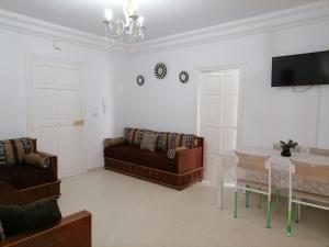 ein Wohnzimmer mit einem Sofa und einem Tisch in der Unterkunft Hergla_AFH_Beach in Harqalah