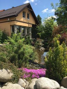a house with a stream in front of a garden at Domček Ami in Stará Lesná