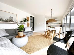 een woonkamer met een bank en een tafel bij Saint Brides - Superior Boutique Accomodation - STEPS TO PAKINGTON STREET in Geelong