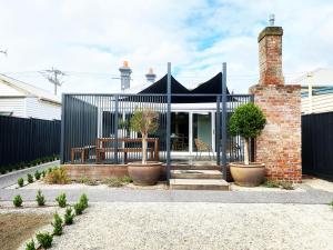 a renovation of a house with a black fence at Saint Brides - Superior Boutique Accomodation - STEPS TO PAKINGTON STREET in Geelong