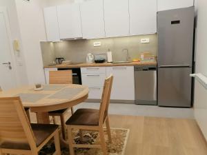 a kitchen with a table and a refrigerator at Beograd centar in Belgrade