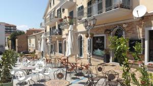 an outdoor patio with tables and chairs and umbrellas at B&B Residenza Aragonese in Vasto