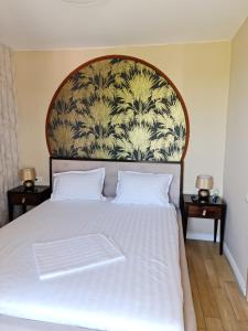 a bedroom with a large bed with a large headboard at Alfa Relax Apartments in Saturn