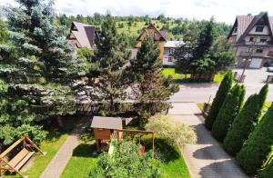 a view of a garden with trees and houses at Willa Seba in Zakopane