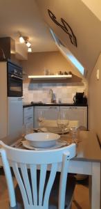 a kitchen with a table with wine glasses on it at Appartement Marigold in Zandvoort