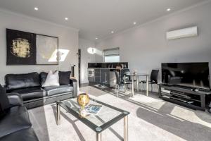 a living room with a couch and a table at TWO FOUR COLOGNE in Martinborough