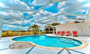 a swimming pool with a retractable roof at !NEW! Villa Waterview in Cape Coral