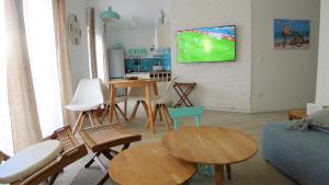 a living room with a tv hanging on a wall at The Duke in Šibenik