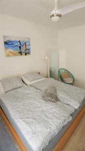 a bed in a bedroom with a painting on the wall at The Duke in Šibenik