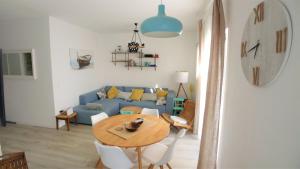 a living room with a table and a blue couch at The Duke in Šibenik