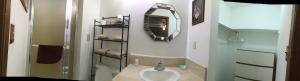 a bathroom with a sink and a mirror at Sunset View Inn L.L.C in Alamo