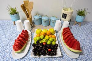 two plates of food with fruit on a table at toptop1 in Majdal Shams