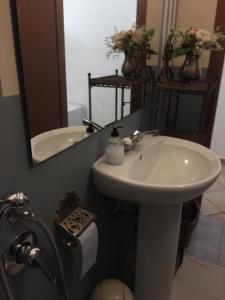 a bathroom with a sink and a mirror at B&B del Giglio in Cefalù