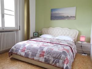 a bedroom with a bed with a quilt on it at The Prime B&B in Pisa