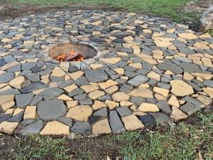 a stone ground with a fire pit in the grass at Just Chillin in Lancelin