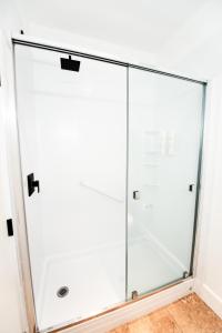 a bathroom with a glass door and a shower stall at Waterton Glacier Suites in Waterton Park