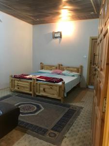 a bedroom with a bed in a room at ViveGee Cottage Khanipur Ayubia in Ayubia
