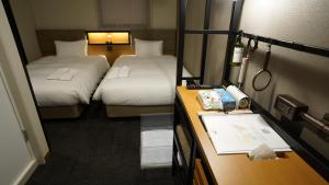 Postel nebo postele na pokoji v ubytování ICI HOTEL Asakusabashi